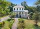 Charming two-story home with manicured lawn, mature trees, and welcoming front porch at 508 N Wake St, Hillsborough, NC 27278