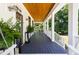 Relaxing front porch with a stained wood ceiling, stylish lighting, and views of the garden at 508 N Wake St, Hillsborough, NC 27278