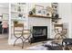 Bright living room featuring a cozy fireplace and custom built-in shelving at 508 N Wake St, Hillsborough, NC 27278