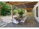 Covered outdoor dining area perfect for al fresco meals and entertaining in a serene setting with natural views at 508 N Wake St, Hillsborough, NC 27278