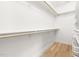 Walk-in closet with wood floor, shelving and wooden bars at 508 N Wake St, Hillsborough, NC 27278