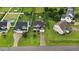 Aerial view of a home with a well-manicured lawn, driveway, and surrounding neighborhood at 52 Summit Overlook Dr, Clayton, NC 27527