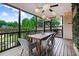 Cozy back porch with a ceiling fan, string lights, table and chairs, and outdoor seating at 52 Summit Overlook Dr, Clayton, NC 27527