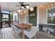 Cozy back porch with a ceiling fan, light, string lights, welcome sign, table and chairs, and outdoor seating at 52 Summit Overlook Dr, Clayton, NC 27527