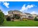 Lush backyard view showcases a patio with seating, a pergola-covered area, and beautiful landscaping at 52 Summit Overlook Dr, Clayton, NC 27527