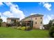 Expansive backyard featuring a well-maintained lawn, screened-in porch, and charming pergola seating area at 52 Summit Overlook Dr, Clayton, NC 27527