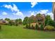 Beautifully landscaped backyard with a pergola-covered seating area and well-manicured lawn at 52 Summit Overlook Dr, Clayton, NC 27527