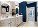 A bathroom with double sinks, a vanity with storage, attractive wallpaper, and designer paint at 52 Summit Overlook Dr, Clayton, NC 27527