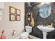 Unique bathroom features a modern vanity, toilet, stylish decorations, and great art on a dark wall at 52 Summit Overlook Dr, Clayton, NC 27527