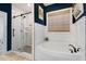 A bathroom with a shower with glass doors, designer paint, and a soaking tub at 52 Summit Overlook Dr, Clayton, NC 27527