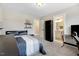 Bright bedroom with a closet, bed, desk, and an ensuite bathroom featuring a sink with white cabinets at 52 Summit Overlook Dr, Clayton, NC 27527