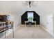 Spacious bonus room featuring a desk under a window, black accent wall, and carpet flooring at 52 Summit Overlook Dr, Clayton, NC 27527