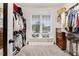 A large walk-in closet with bench seating, storage, and window views at 52 Summit Overlook Dr, Clayton, NC 27527
