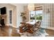 Charming dining area with a wooden table, bench seating, and a stylish chandelier with great natural light at 52 Summit Overlook Dr, Clayton, NC 27527