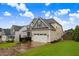 Side view of a modern two-story home with a well-maintained lawn and a two-car garage at 52 Summit Overlook Dr, Clayton, NC 27527