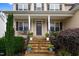 Inviting front porch with stone steps, railing, and a decorative front door at 52 Summit Overlook Dr, Clayton, NC 27527