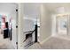A light-filled hallway with carpeting and access to other rooms in the home at 52 Summit Overlook Dr, Clayton, NC 27527