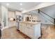 Open kitchen area features a spacious island with seating and modern appliances with seamless flow to living area at 52 Summit Overlook Dr, Clayton, NC 27527