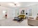 Bright living room features a modern light fixture, two windows, and comfortable seating with a coffee table at 52 Summit Overlook Dr, Clayton, NC 27527