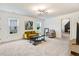 Spacious living room features a modern light fixture, two windows, and comfortable seating with a coffee table at 52 Summit Overlook Dr, Clayton, NC 27527