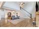 Bright living room features vaulted ceilings, hardwood floors, a fireplace, and an open staircase at 52 Summit Overlook Dr, Clayton, NC 27527