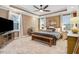 Comfortable main bedroom features a tray ceiling, neutral colors, a ceiling fan, and ample natural light at 52 Summit Overlook Dr, Clayton, NC 27527