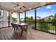 Screened-in porch featuring a dining table, chairs, and decorative lighting at 52 Summit Overlook Dr, Clayton, NC 27527