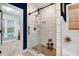 A bathroom with a shower that features white tile, black hardware, and glass door at 52 Summit Overlook Dr, Clayton, NC 27527