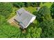 An aerial view of a home featuring a gray roof, long driveway, a spacious backyard, and mature trees at 5309 Meadow Field Dr, Mebane, NC 27302