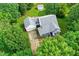 Aerial view of a home featuring a gray roof, long driveway, a spacious backyard, and mature trees at 5309 Meadow Field Dr, Mebane, NC 27302
