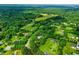 Aerial community view with homes surrounded by lush green lawns and mature trees within a rural setting at 5309 Meadow Field Dr, Mebane, NC 27302