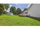 Large backyard with a deck, shed, well-maintained lawn, and plenty of mature trees at 5309 Meadow Field Dr, Mebane, NC 27302