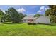 Spacious backyard with deck, well-maintained lawn, mature trees, and a detached shed at 5309 Meadow Field Dr, Mebane, NC 27302
