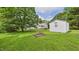 Large backyard with a shed, fire pit, and ample green space, perfect for outdoor activities at 5309 Meadow Field Dr, Mebane, NC 27302