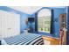 Blue bedroom with a vaulted ceiling, large window, and playful dinosaur decor at 5309 Meadow Field Dr, Mebane, NC 27302
