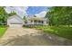 View of home with a detached garage, a basketball hoop, and an inviting front porch at 5309 Meadow Field Dr, Mebane, NC 27302