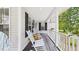 A well-decorated front porch with a swing and rocking chairs creates a welcoming spot at 5309 Meadow Field Dr, Mebane, NC 27302
