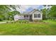 Charming home with a well-manicured lawn, lovely landscaping, and a welcoming front porch at 5309 Meadow Field Dr, Mebane, NC 27302