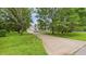 Charming home with a two-car garage and a long driveway surrounded by mature trees and lush green grass at 5309 Meadow Field Dr, Mebane, NC 27302