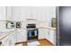 Bright kitchen with white cabinets, stainless steel appliances, and wood-look countertops at 5309 Meadow Field Dr, Mebane, NC 27302