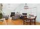 Open-concept living and dining area with a fireplace, ceiling fan, and wood floors at 5309 Meadow Field Dr, Mebane, NC 27302