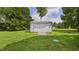 Backyard shed with a small deck in a spacious, grassy yard at 5309 Meadow Field Dr, Mebane, NC 27302