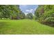 Expansive grassy yard with mature trees, offering ample space and natural beauty at 5309 Meadow Field Dr, Mebane, NC 27302