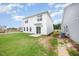 Exterior of the two-story home featuring a well-manicured lawn and a sliding glass door that offers easy access at 58 W Emily Gardens Dr, Selma, NC 27576