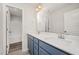 Bathroom with double sinks, blue cabinets, and tile floors at 58 W Emily Gardens Dr, Selma, NC 27576