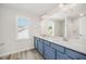 Bathroom with double sinks and a large mirror, and a view of the backyard at 58 W Emily Gardens Dr, Selma, NC 27576