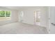 Large bright bedroom with two big windows and light colored walls and carpet at 58 W Emily Gardens Dr, Selma, NC 27576