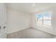 Bright bedroom featuring plush carpet, a window, and neutral colored paint at 58 W Emily Gardens Dr, Selma, NC 27576