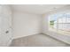 Bright bedroom featuring plush carpet, a window, and neutral colored paint at 58 W Emily Gardens Dr, Selma, NC 27576