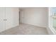 Bright bedroom featuring plush carpet, a window, and neutral colored paint at 58 W Emily Gardens Dr, Selma, NC 27576